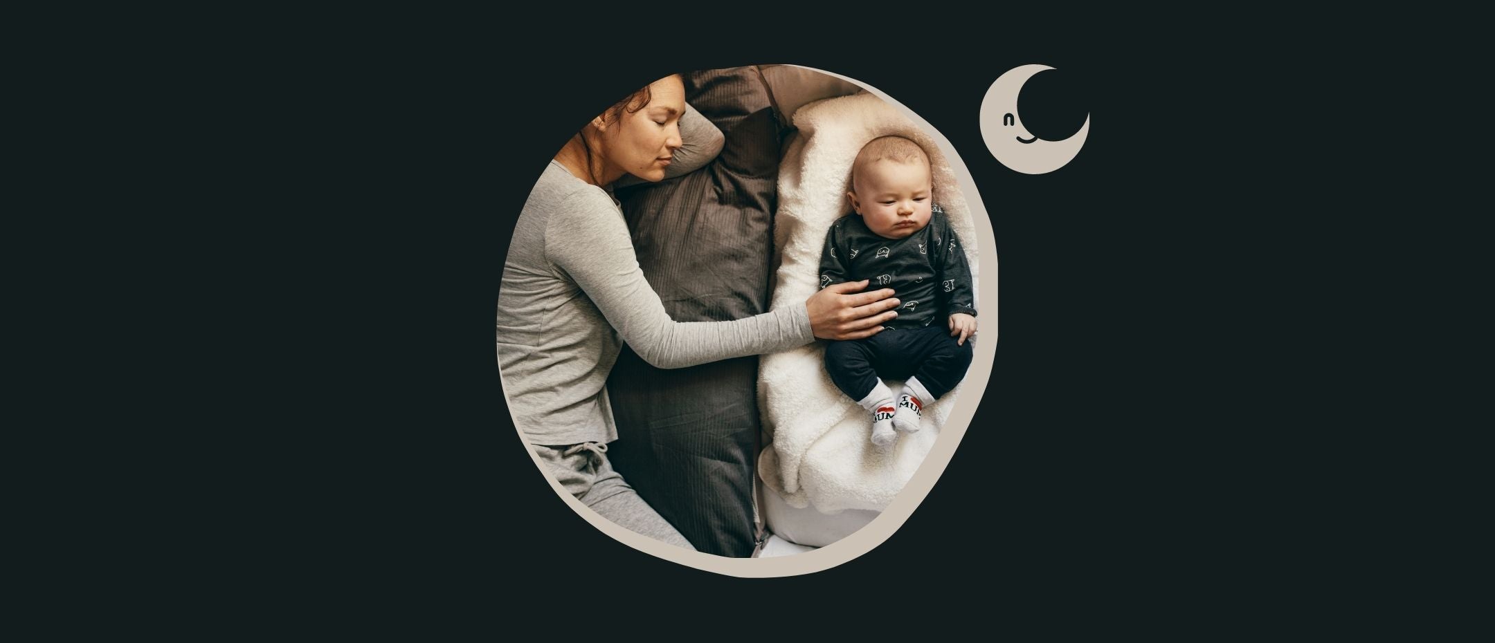 mother sleeping with her baby in the bassinet