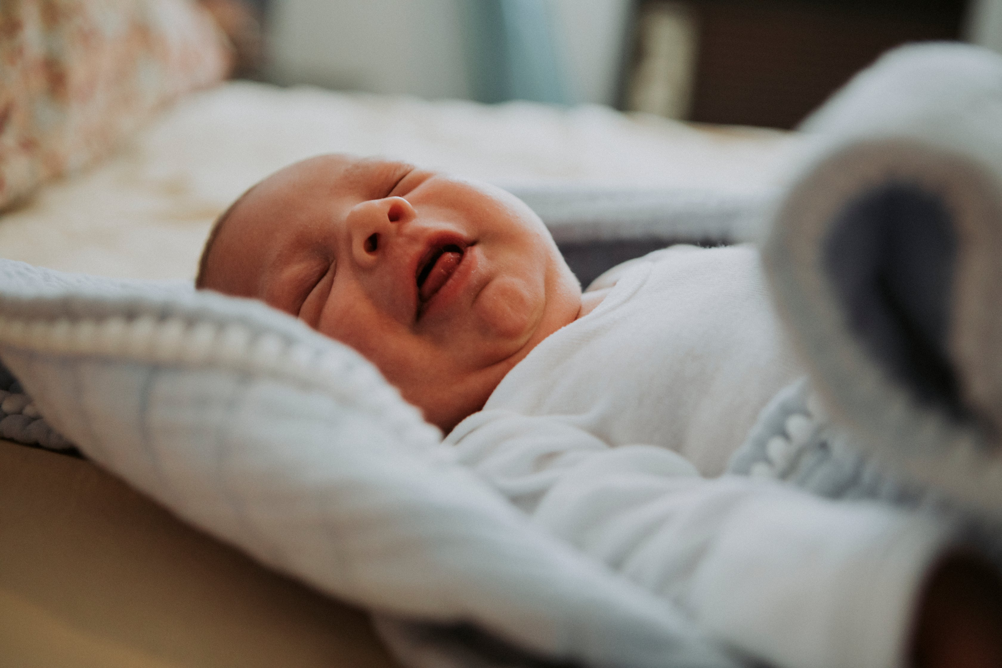 Infant baby yawing in bed