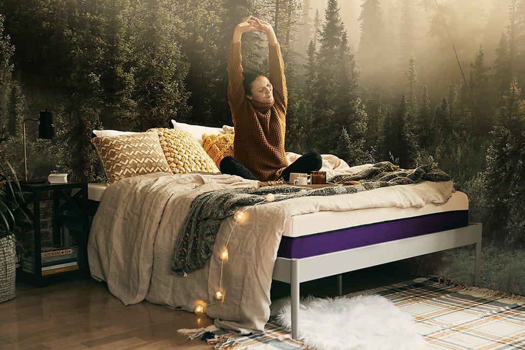 A woman is stretching her back on the Polysleep mattress