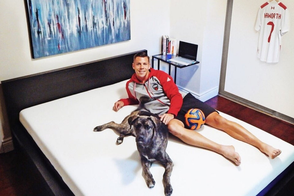 Athele on his mattress with his dog