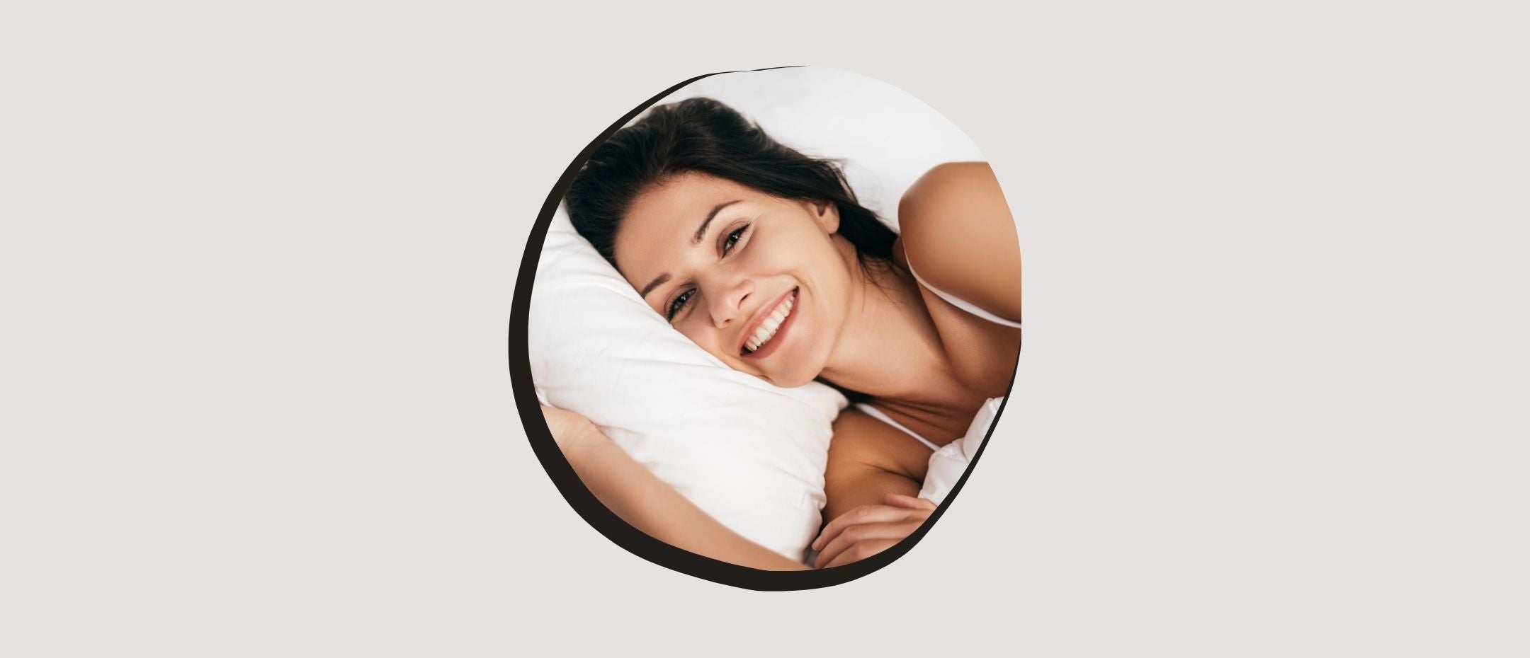 Smiling woman lying on the right mattress