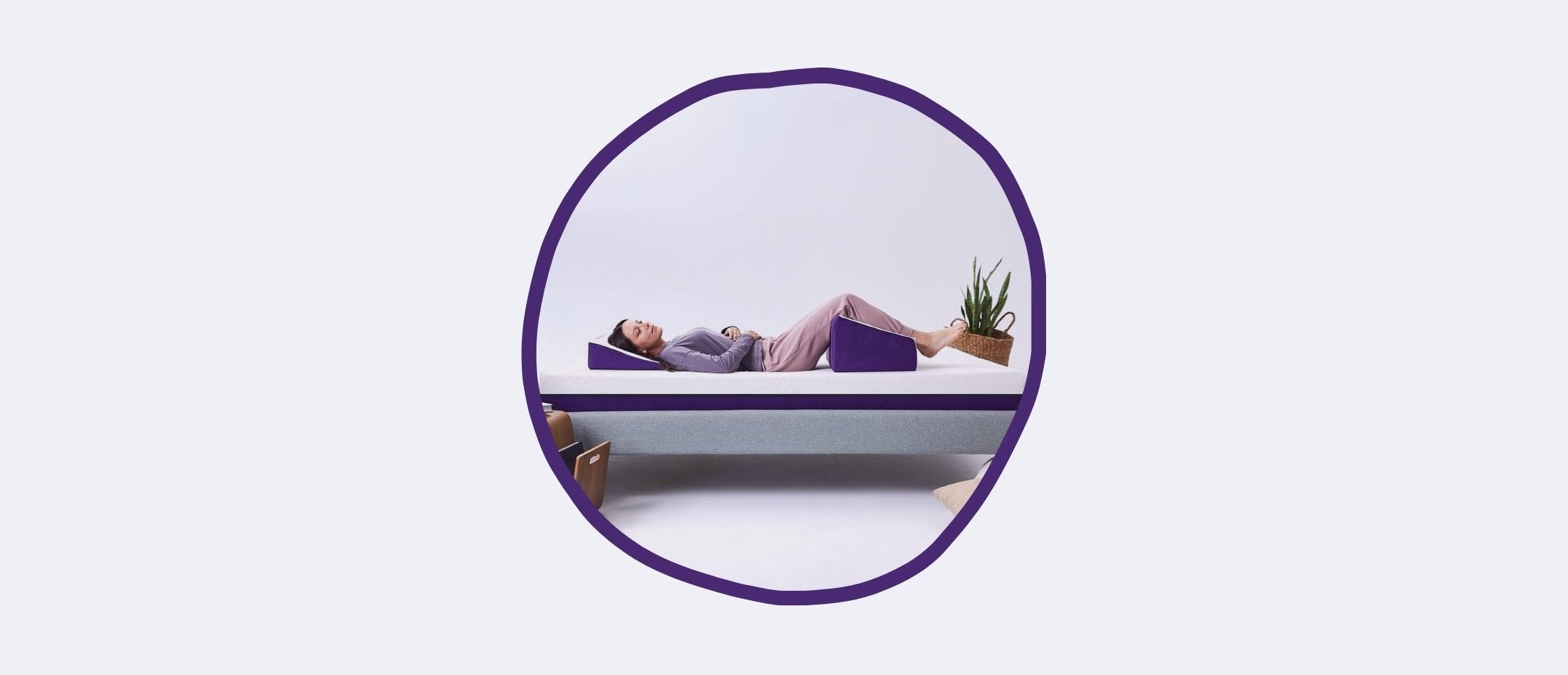 Woman lying legs raised on Polysleep triangular pillow