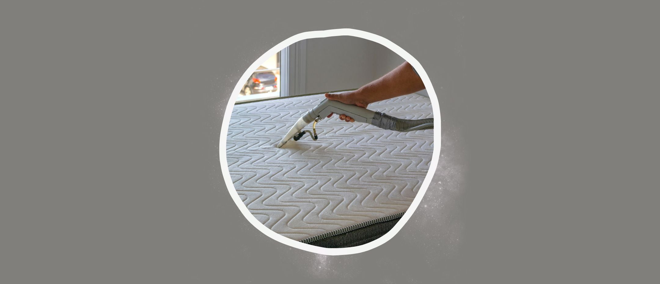 Hand vacuuming a mattress to dry it.